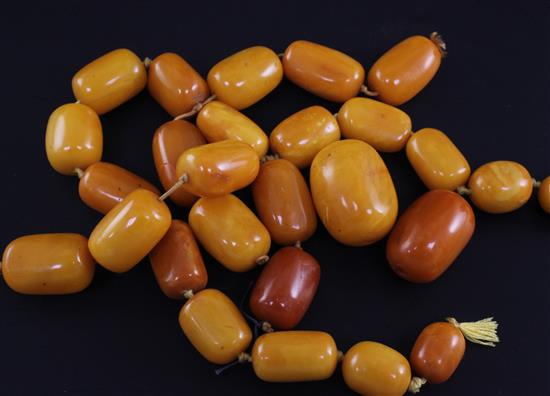Twenty seven graduated amber beads,